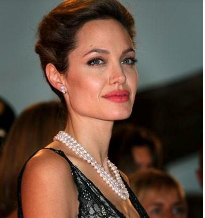 Angelina Jolie usando um elegante colar de pérolas em um evento de gala.
